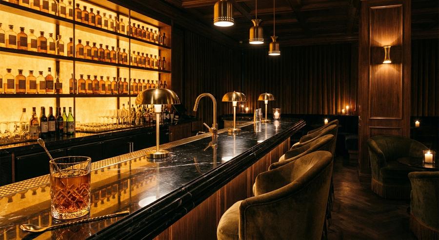 Black marble bar with backlit amber shelves